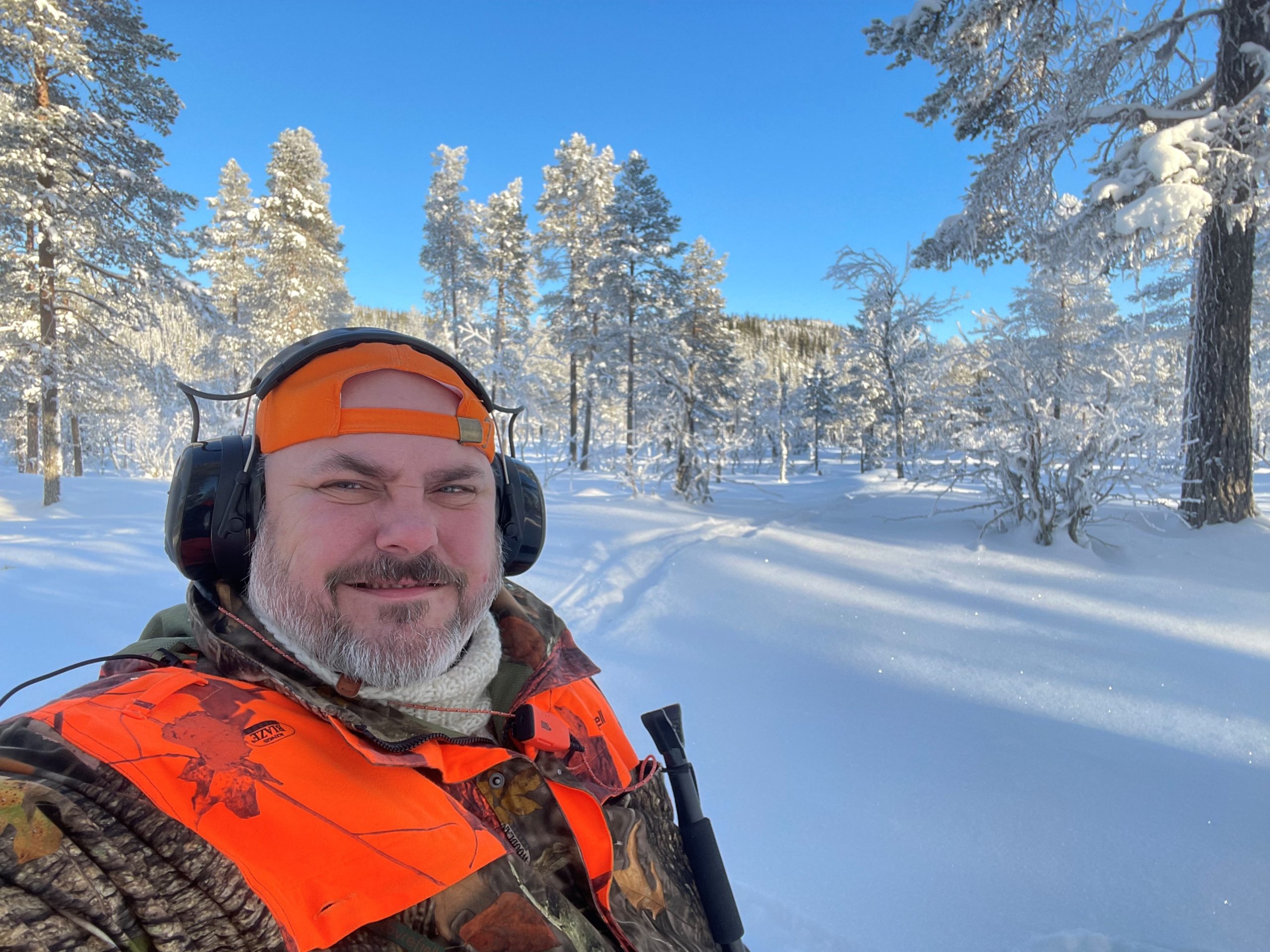 Adult John snowshoe walking in sunny winter wonderland