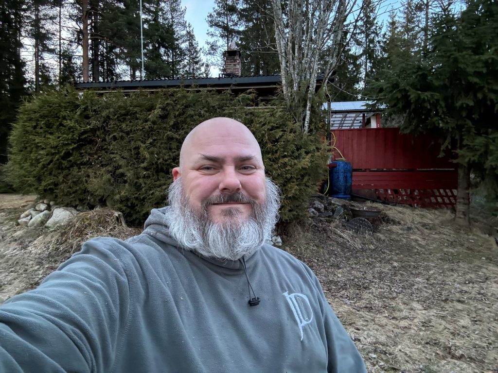 John in front of cottage