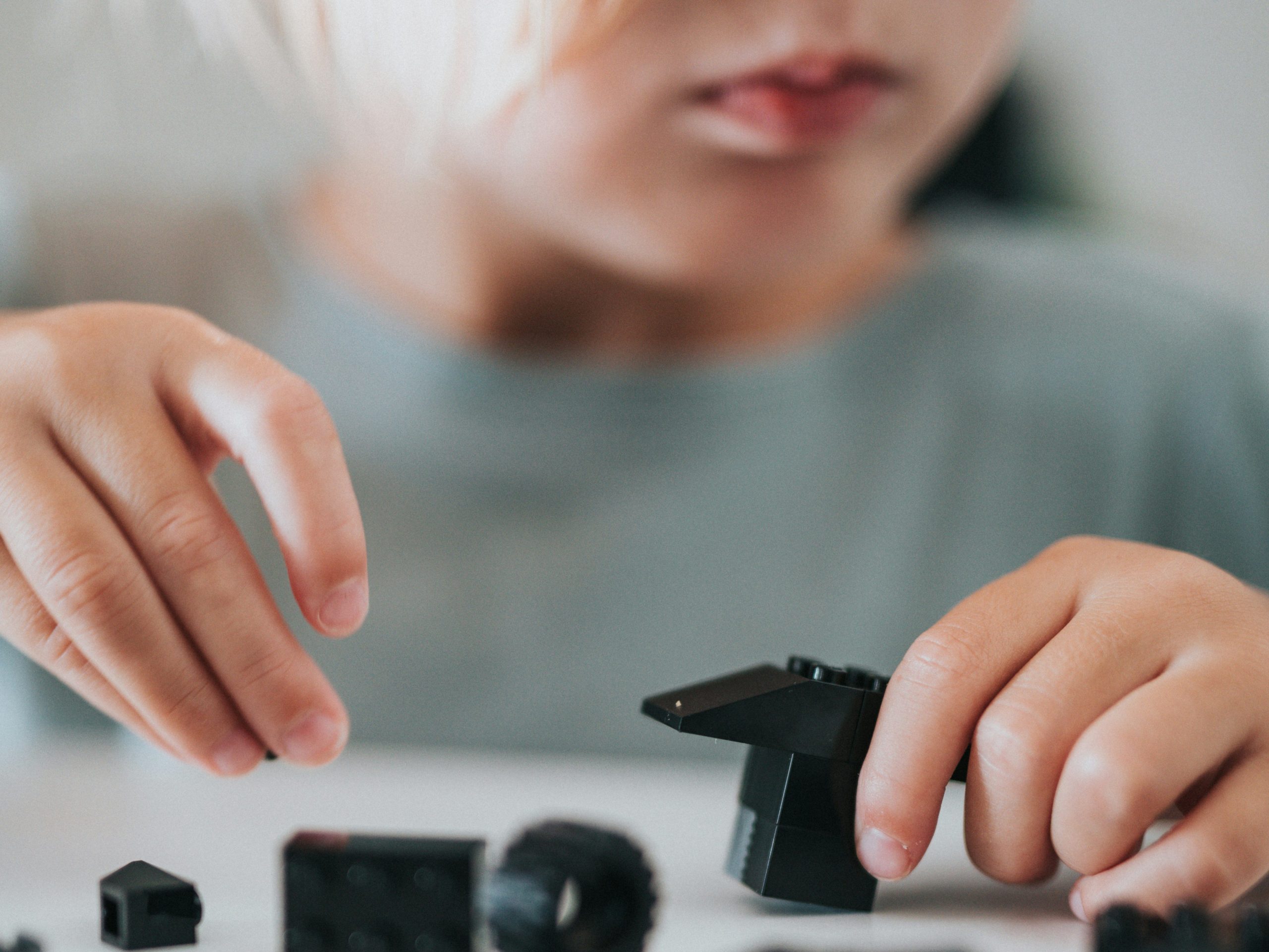Adolescent boy playing with Lego